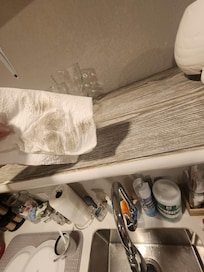 Dirty kitchen shelves where dishes are stored