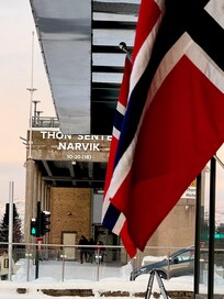 Looking across lobby entrance at mall next door where there’s a grocery and drug store
