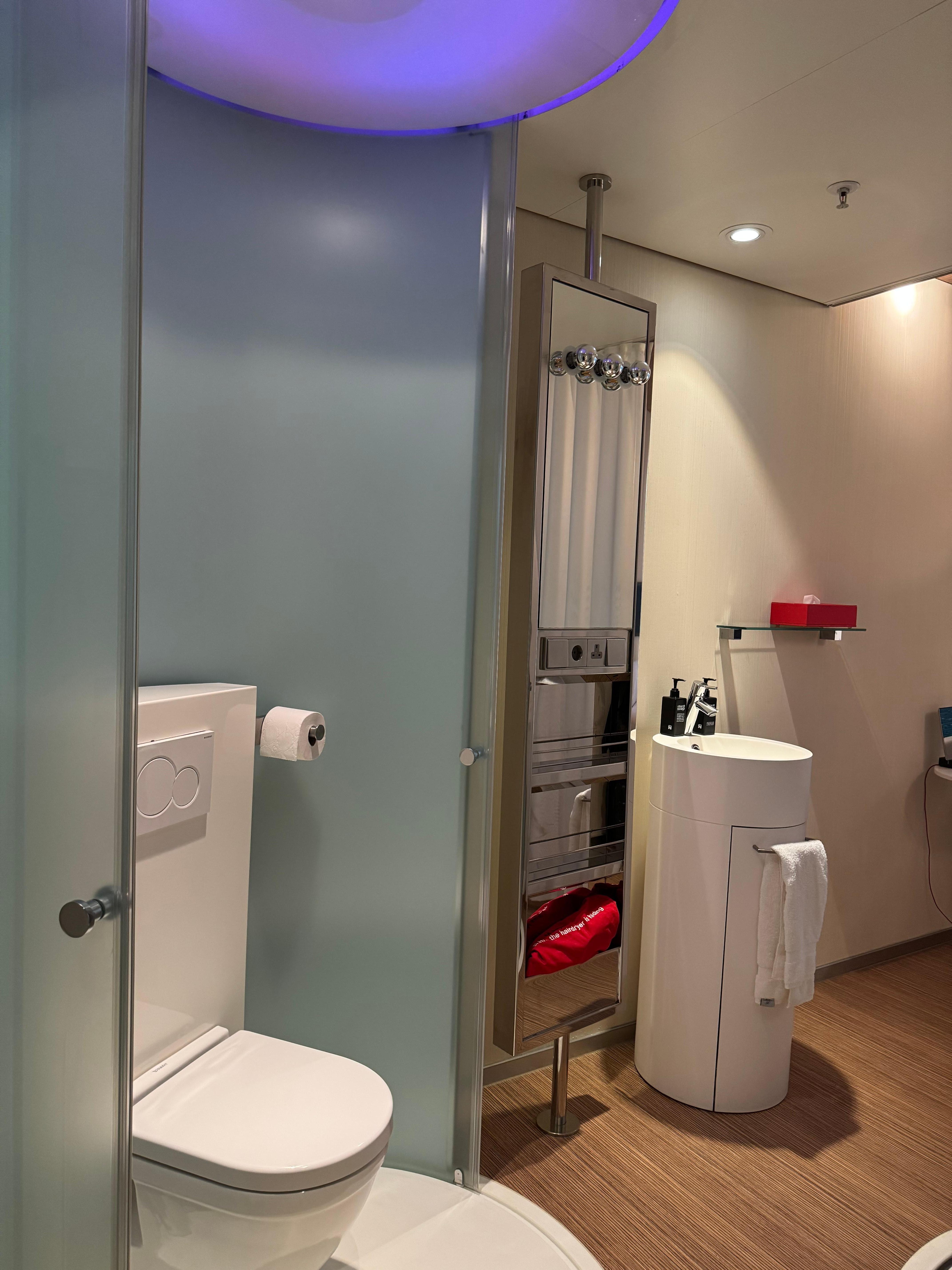 Toilet and sink in middle of room