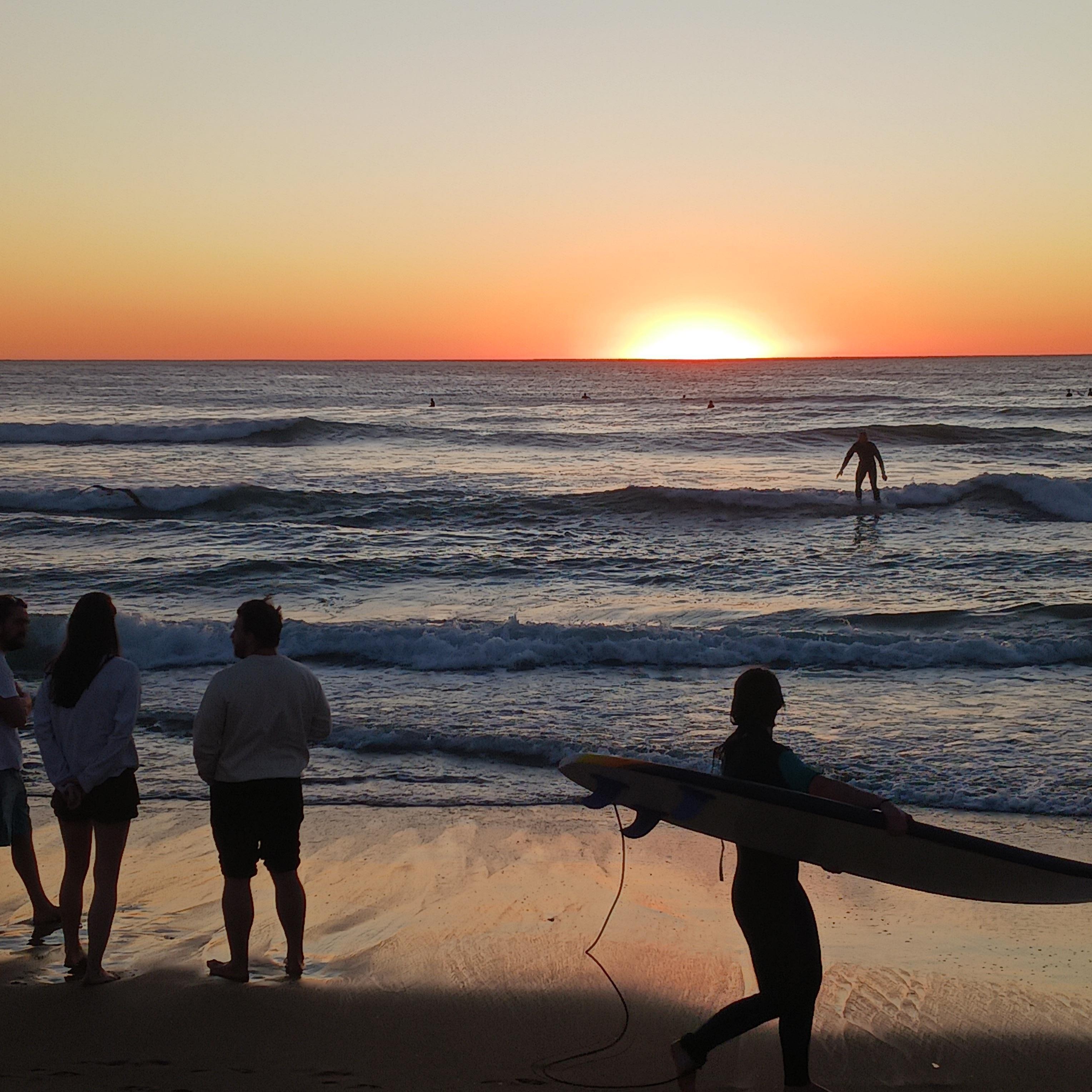 Surfing at sunset at OB