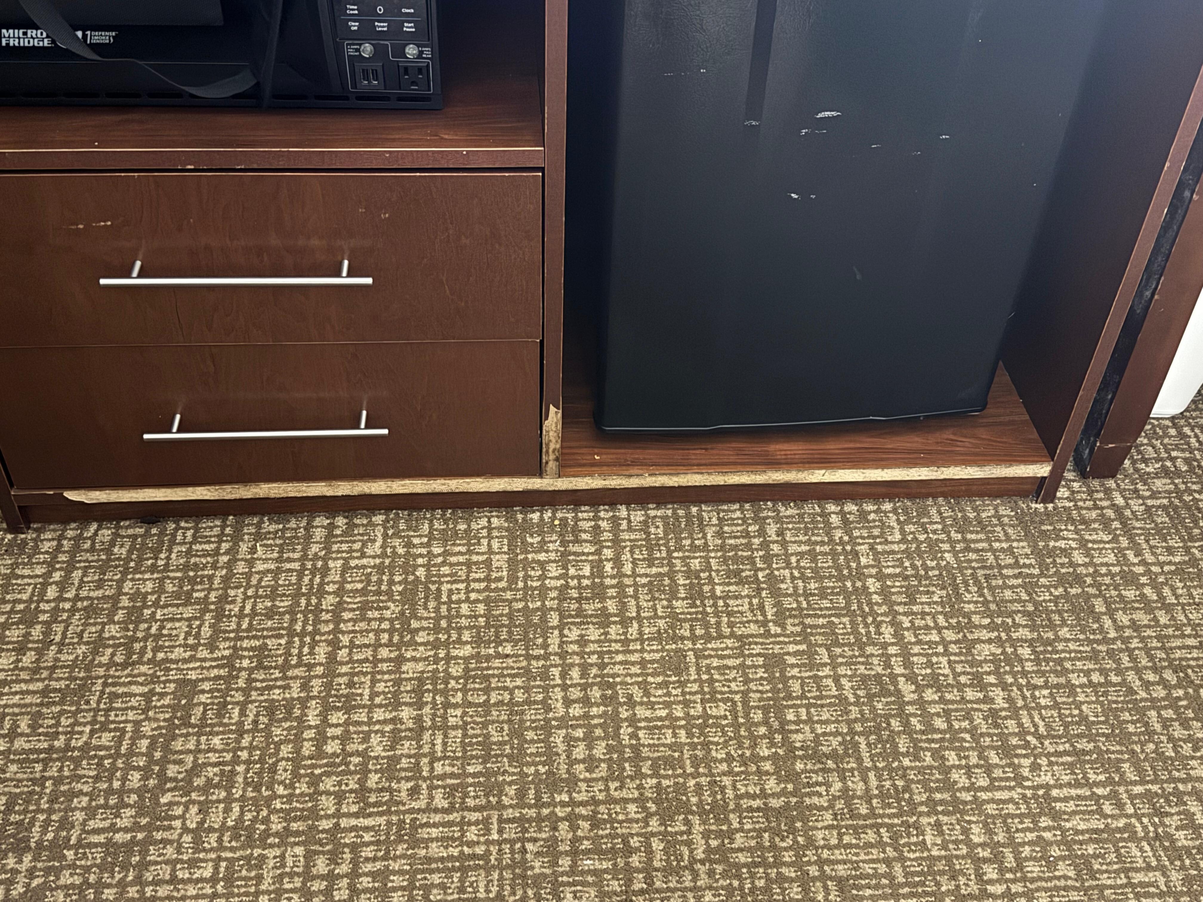 Broken furniture and dirty rug