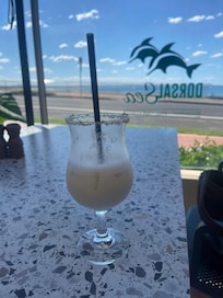 Pina Colada cocktail. The Dorsal by the sea Restaurant outside dining ground floor.