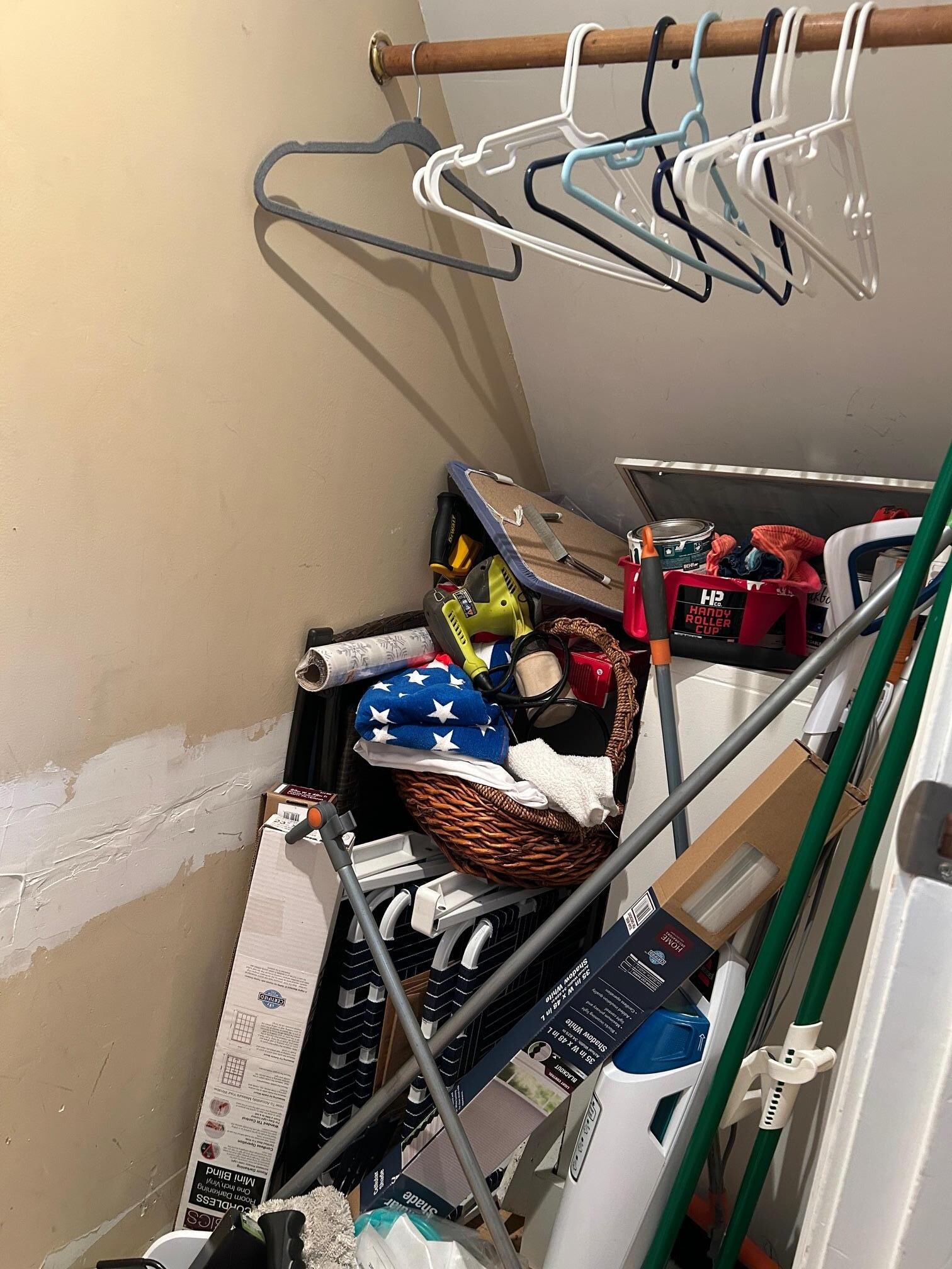 The iron and ironing board listed under amenities are somewhere in there. Along with old paint cans.