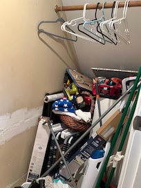 The iron and ironing board listed under amenities are somewhere in there. Along with old paint cans.