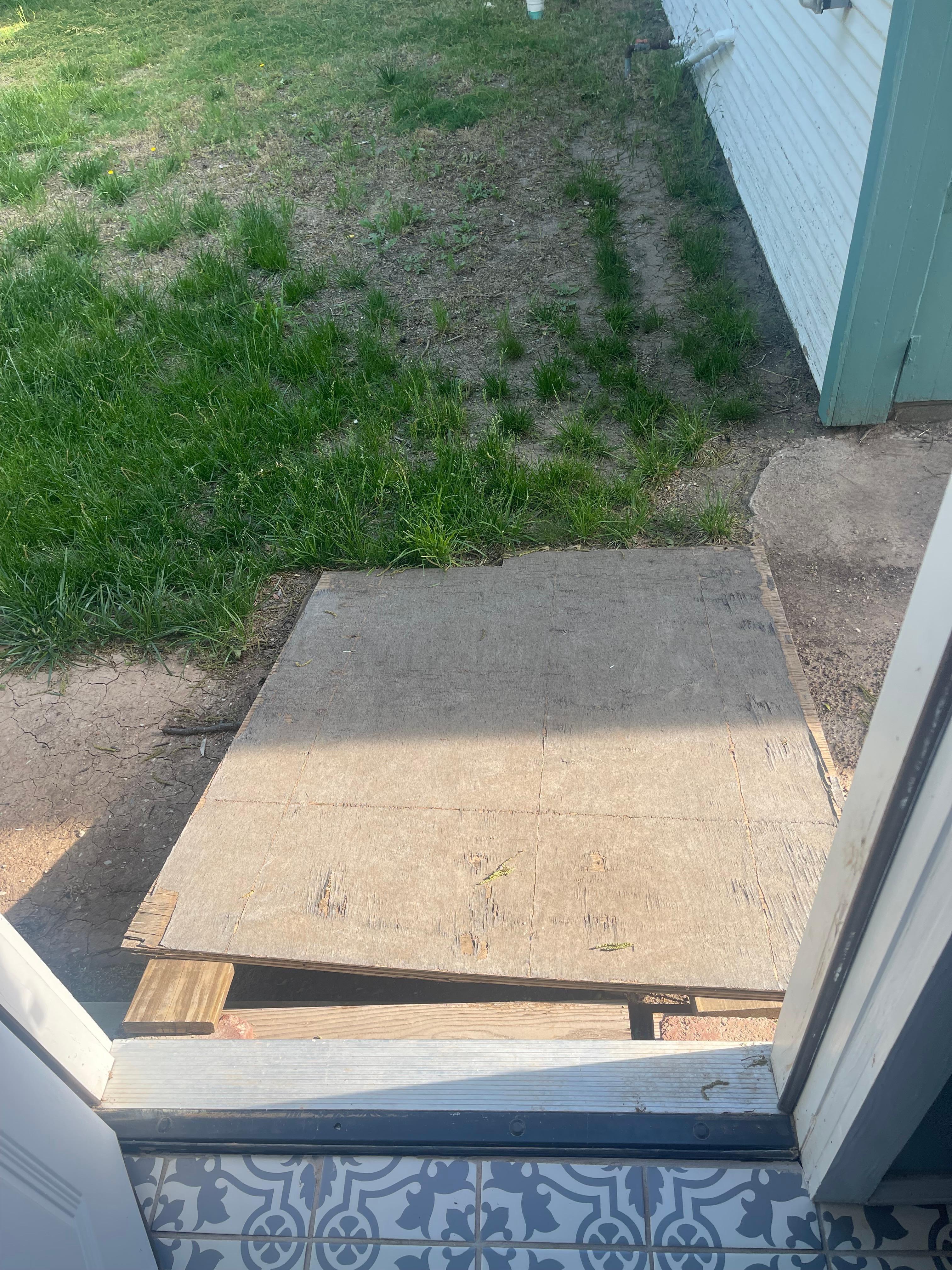 Ramp outside back door was very unstable & had a gap between the house & board seen here. If anyone, even a pet, were to step down into the gap, it could cause injury. 