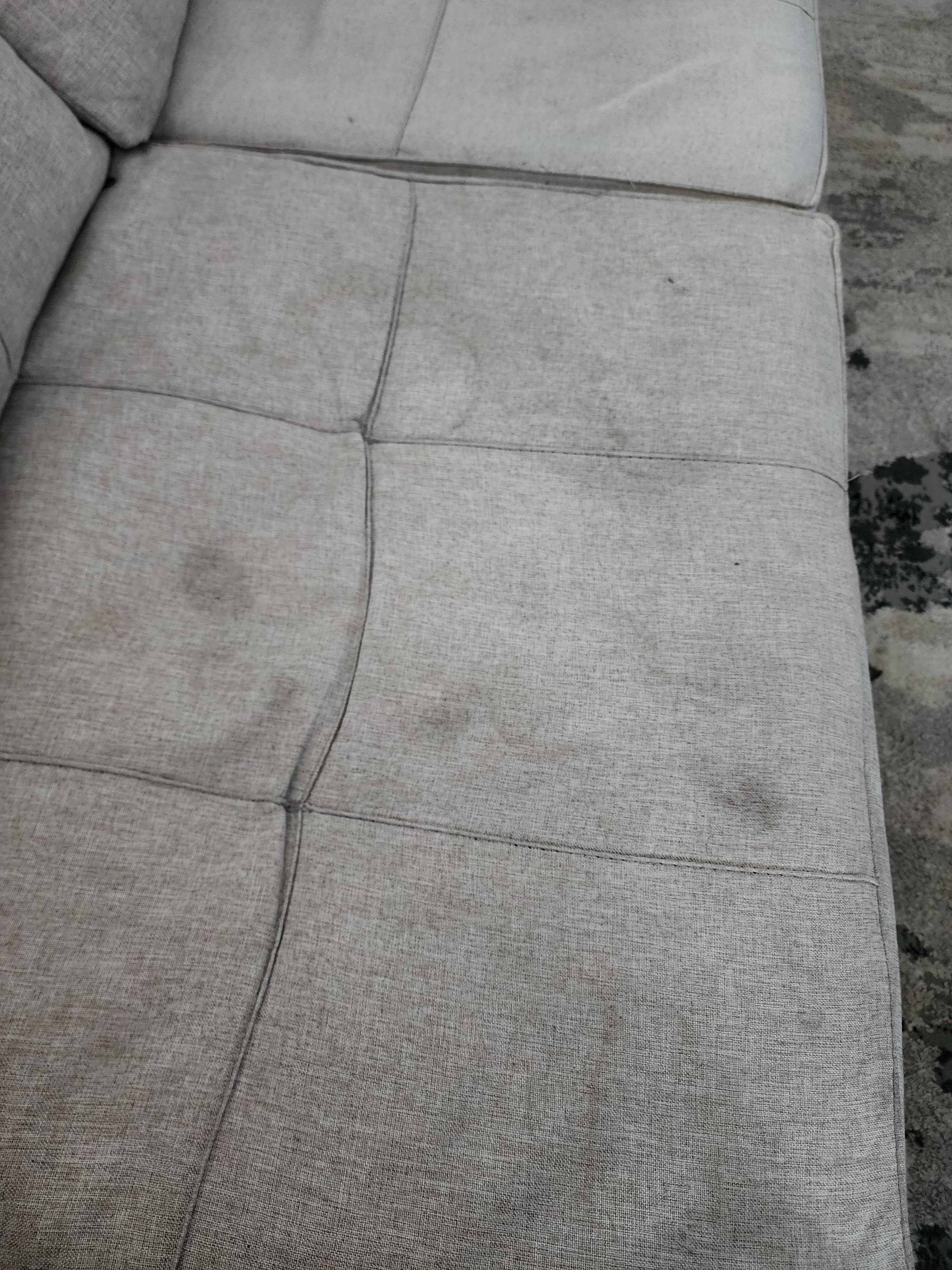 Couch covered with filth and stains. 