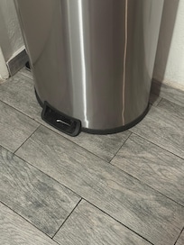 Trash can pedal, a piece of jagged metal to step on, no pedal covering the jagged metal.