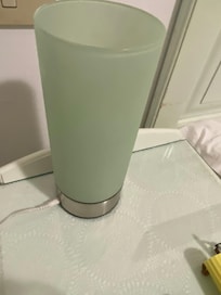 Lamp on nightstand table with globe
