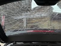 Damage from the poorly lit parking garage and pipe protruding off the wall.