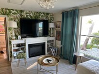 Living room with large smart TV & electric fireplace