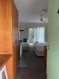 cupboard space, with extra blankets, iron and ironing board