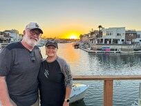 Son and wife on deck of home.