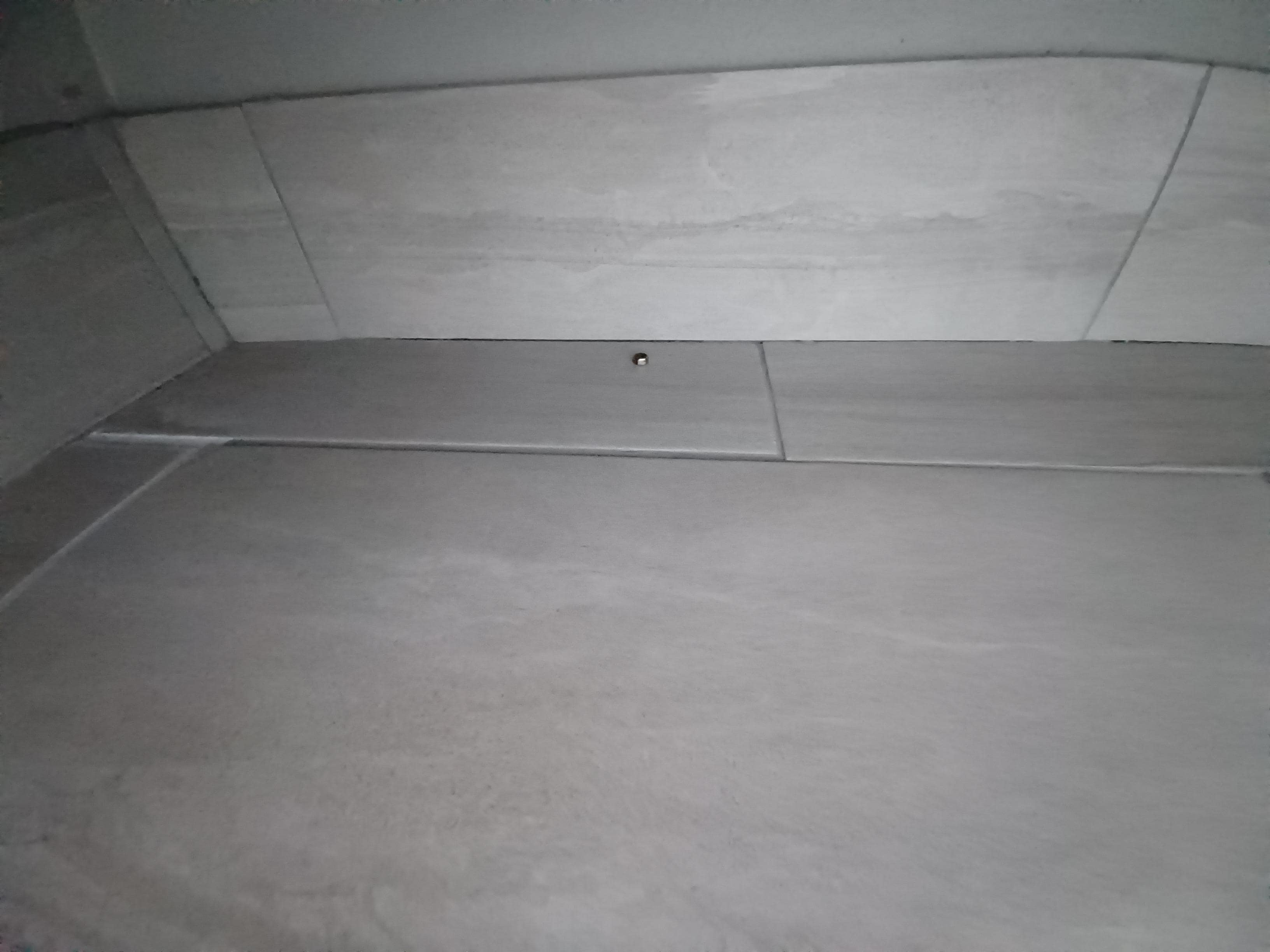 Food remnants under sink in bathroom.