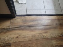 Loosen flooring right at the bathroom entrance
