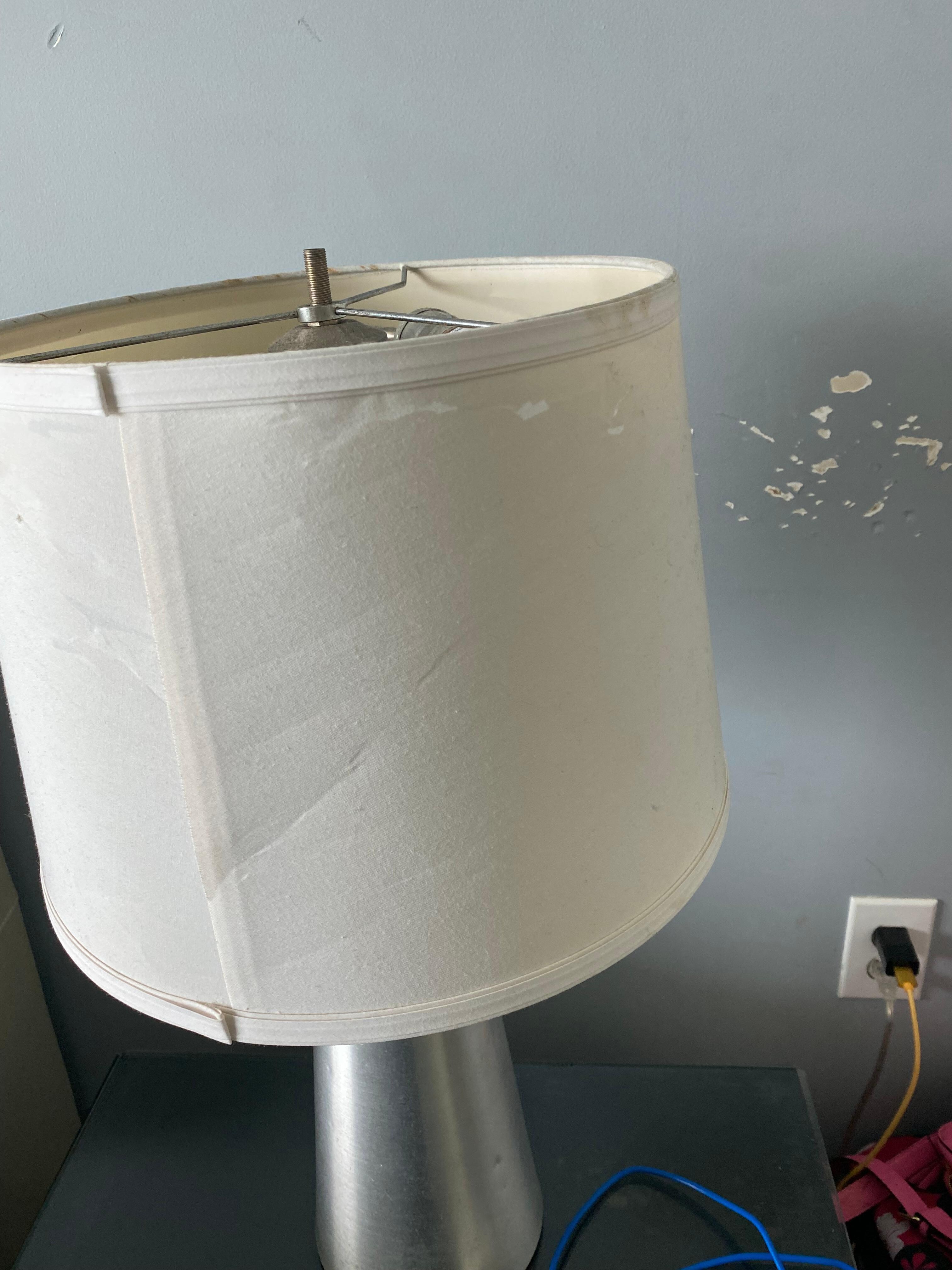 Scuffed, stained wall & beat up lampshade 