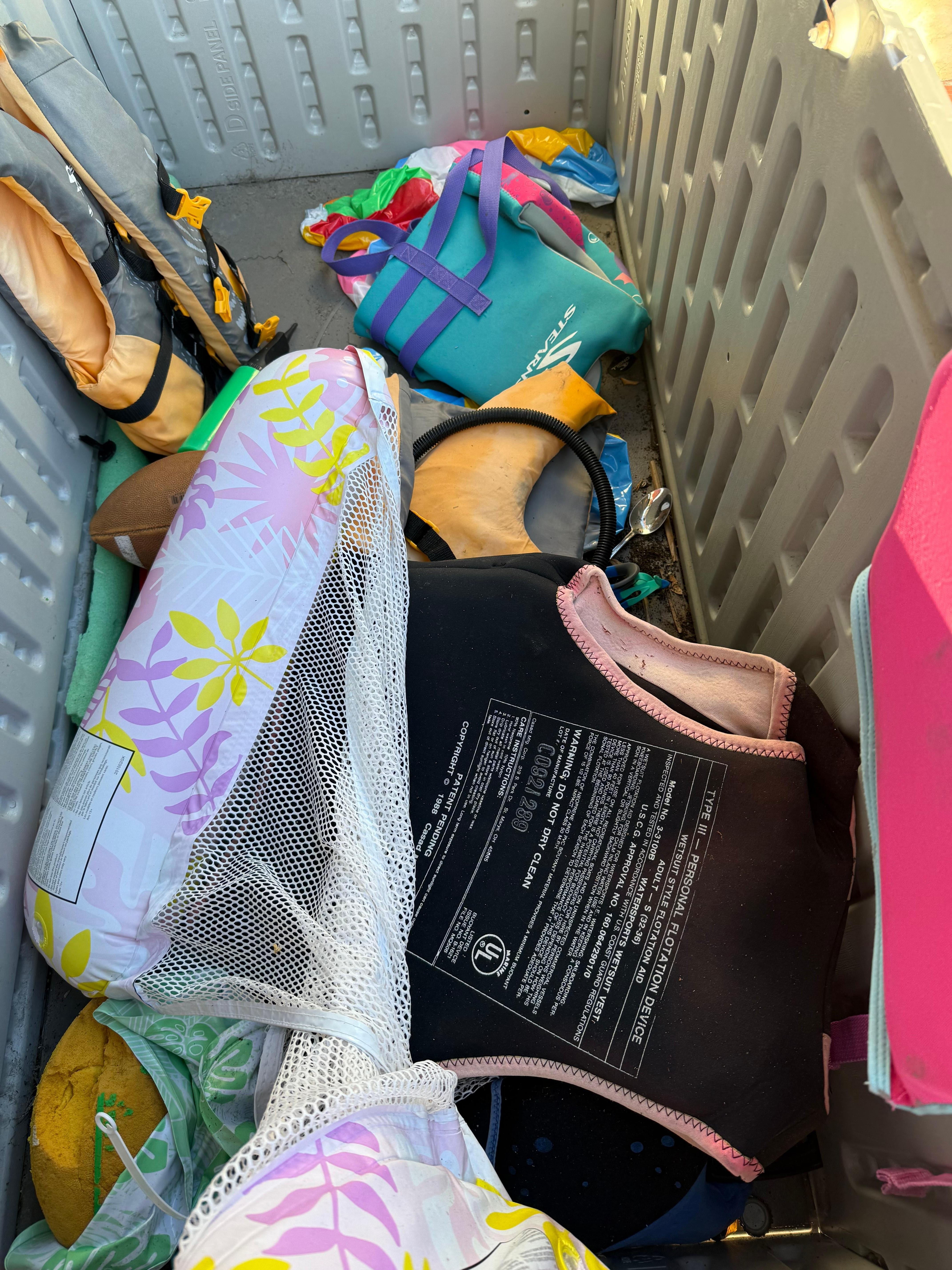 Cluttered and dirty pool toy area. Spoons and bandaids included.