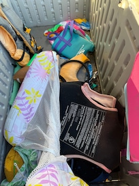 Cluttered and dirty pool toy area. Spoons and bandaids included.