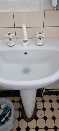 Drainage slow in bathroom sink, which was also dirty, as were tiles.