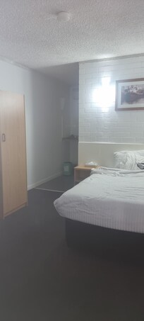 the whole room from door, ensuite behind bed.