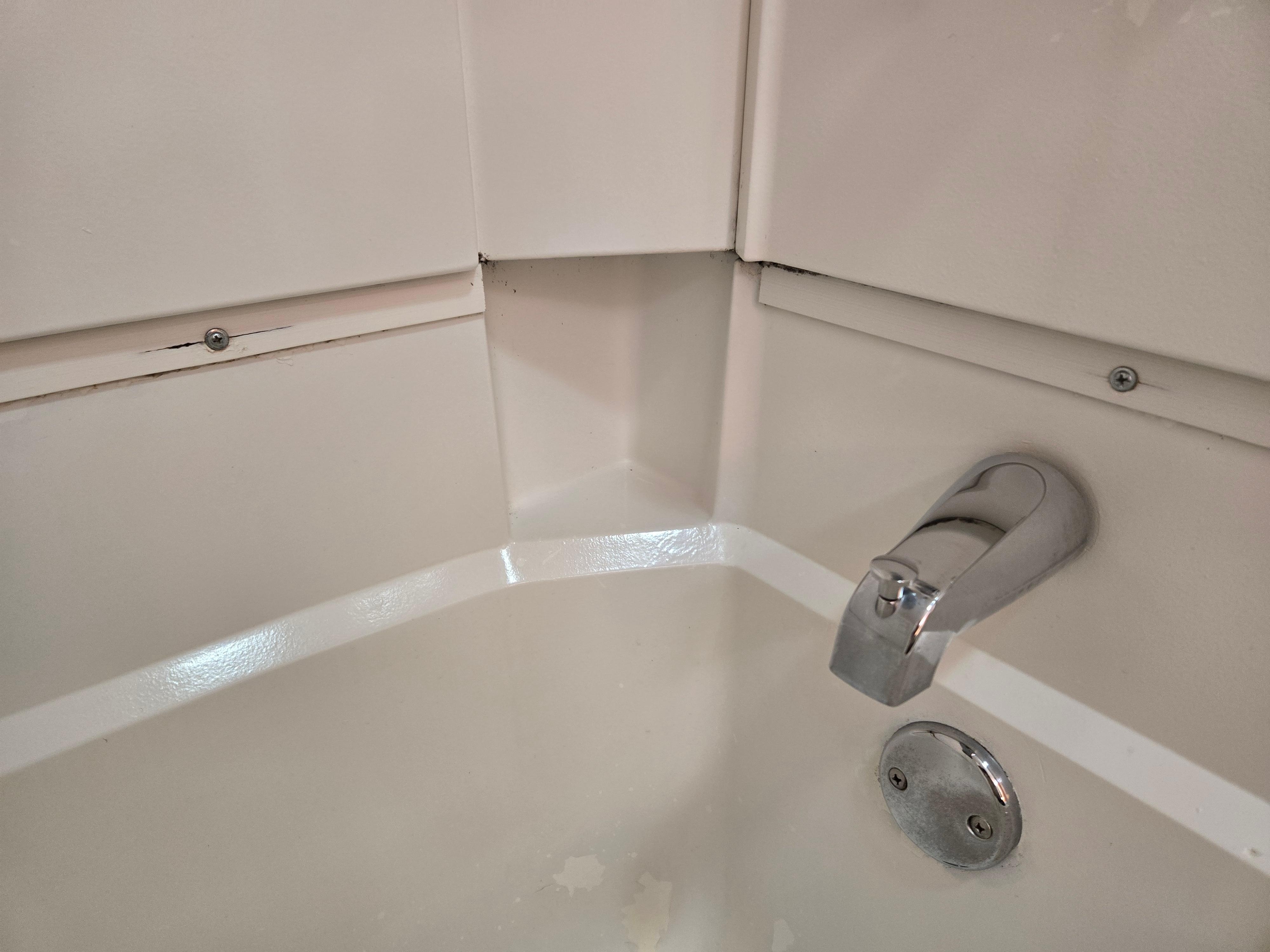 Exposed screws and gaps in tub/ shower unit