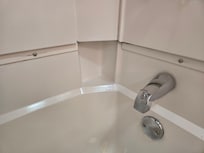 Exposed screws and gaps in tub/ shower unit