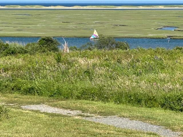 A sailboat heads down a channel,