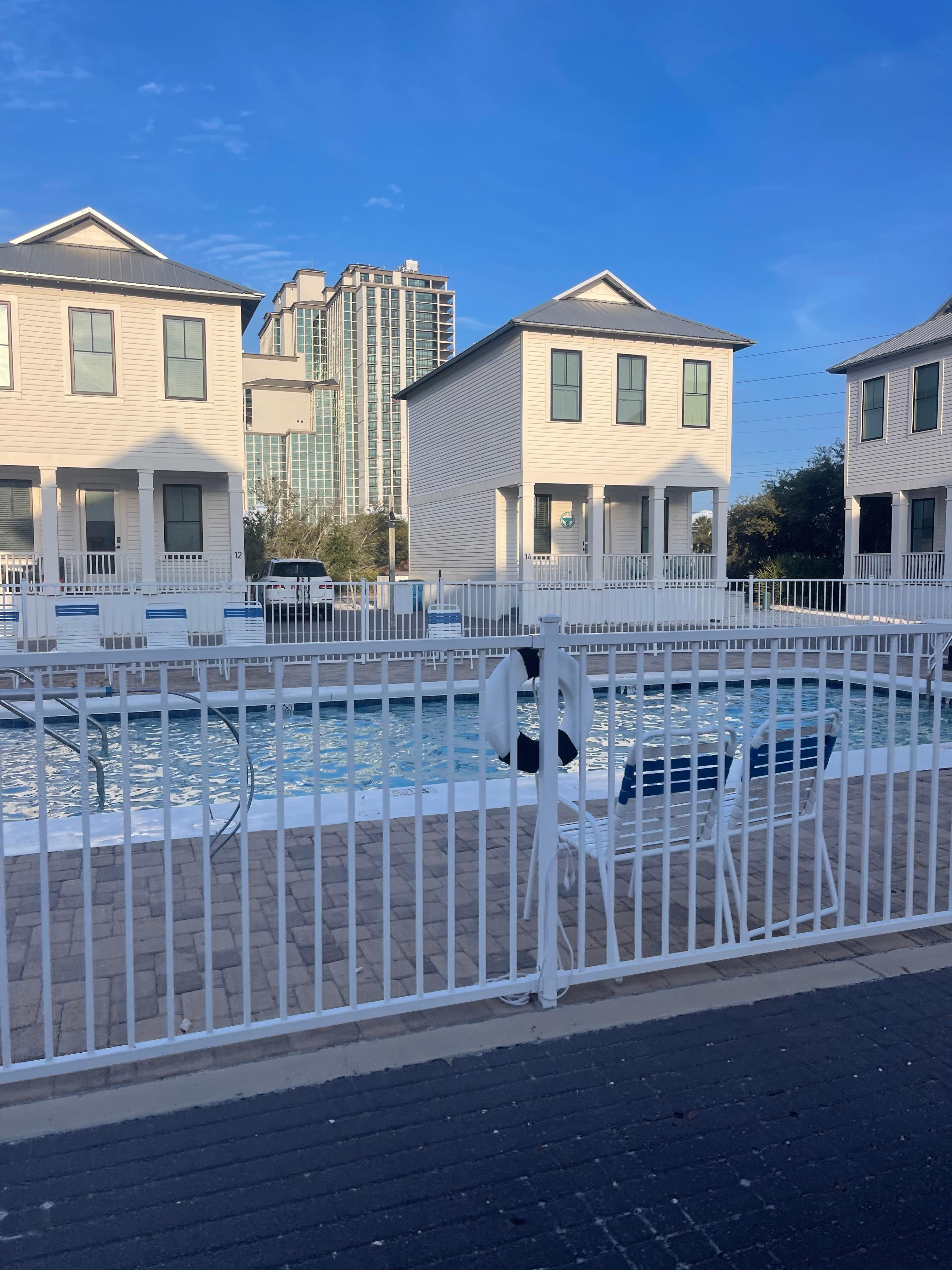Front of house with pool right outside the front door 