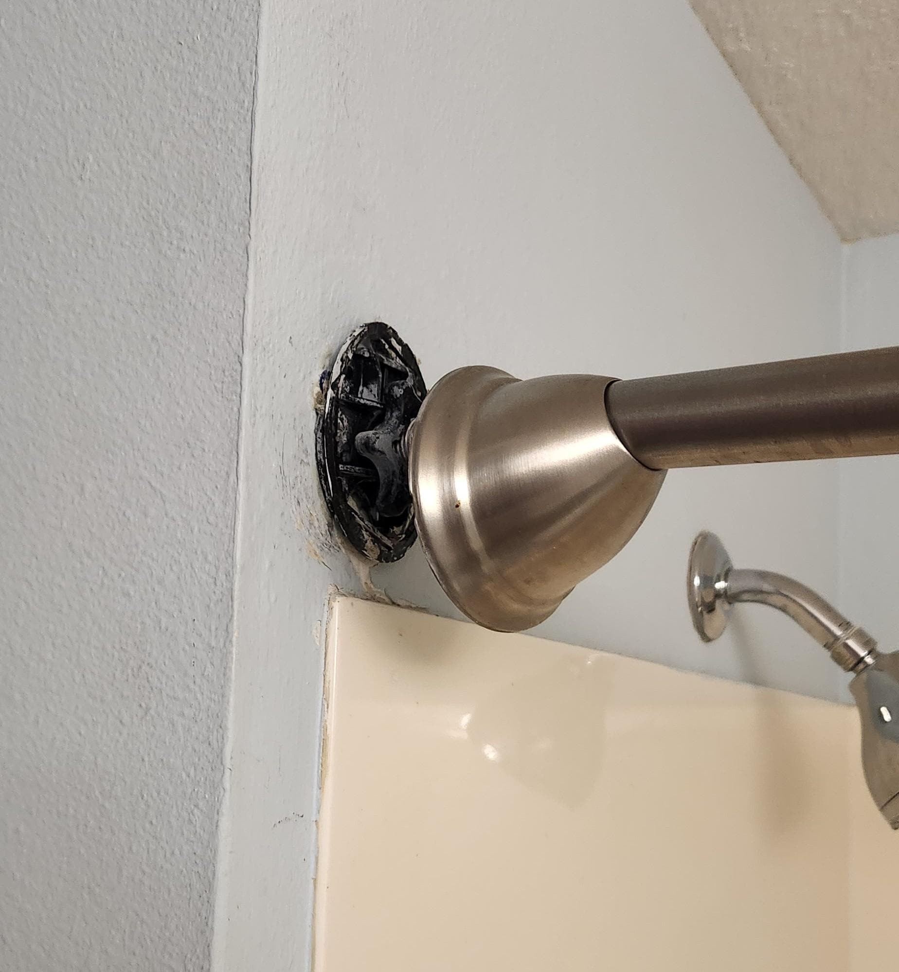 Shower rod caps & rod barely holding on.