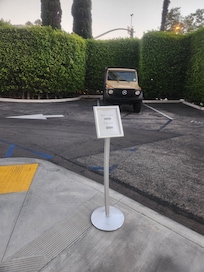 Directions in parking lot to the side of the building to get to the elevator.