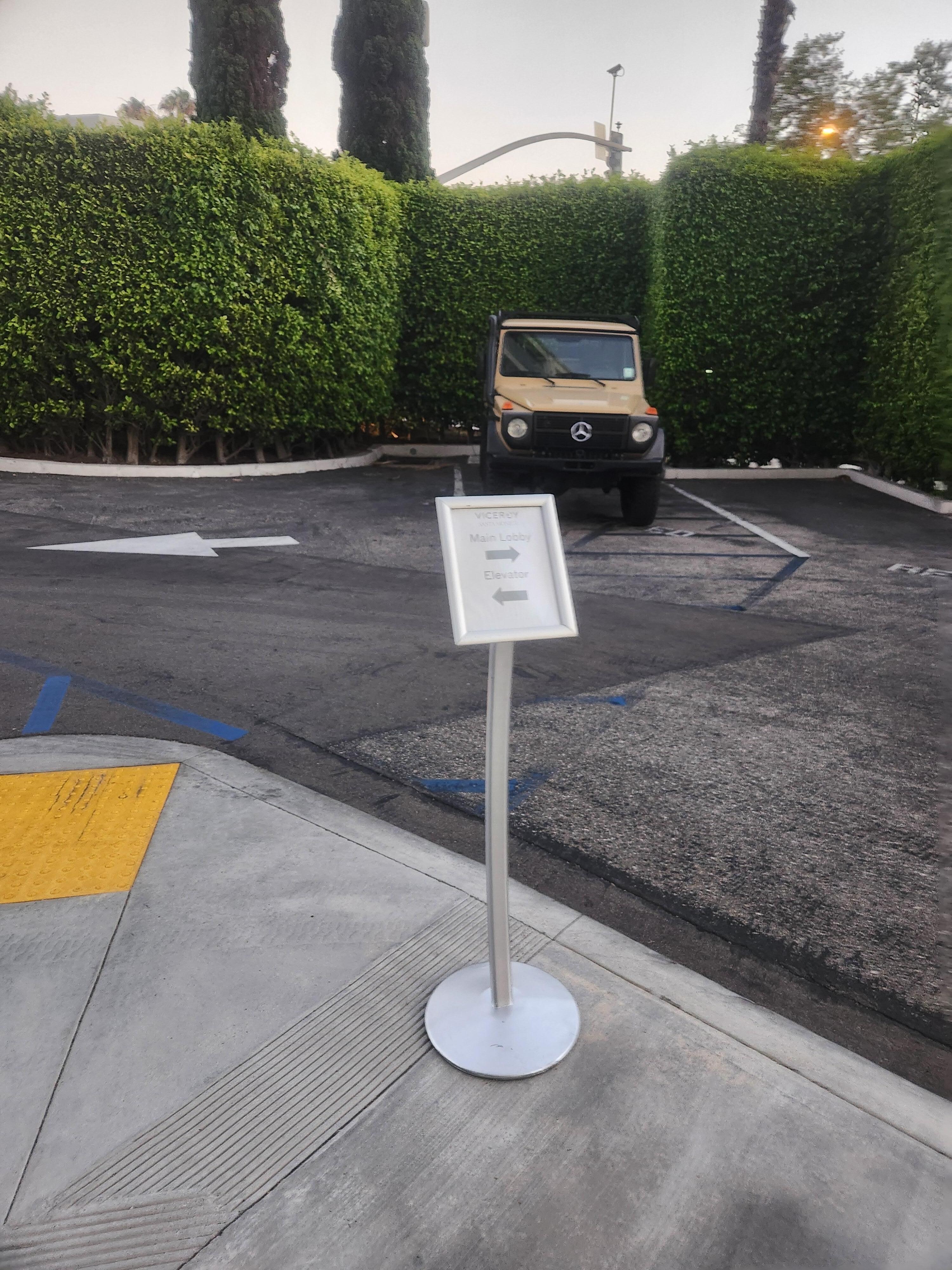 Directions in parking lot to the side of the building to get to the elevator.