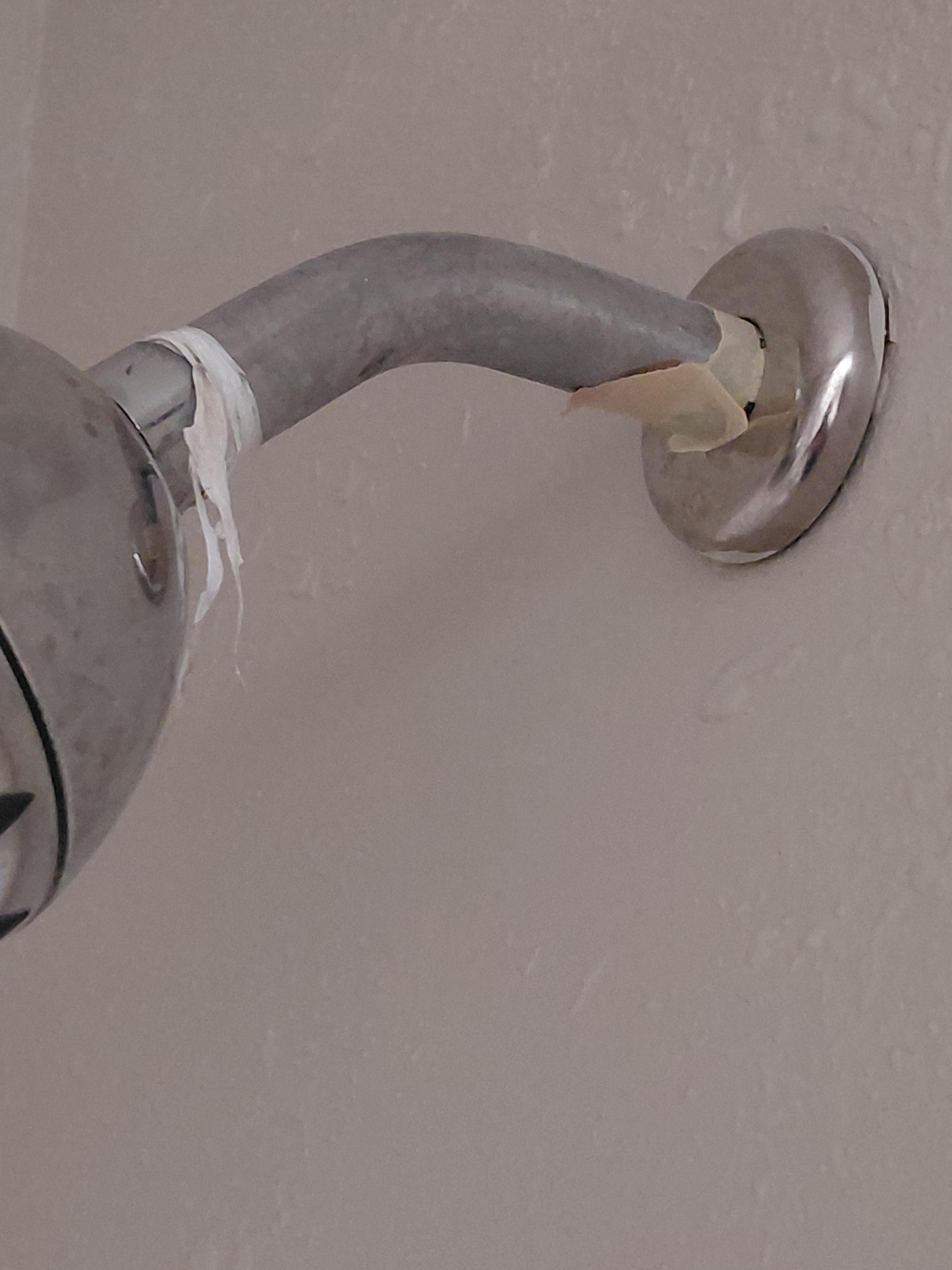 Pipe thread tape hanging and tape around shower pipe