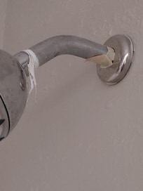 Pipe thread tape hanging and tape around shower pipe
