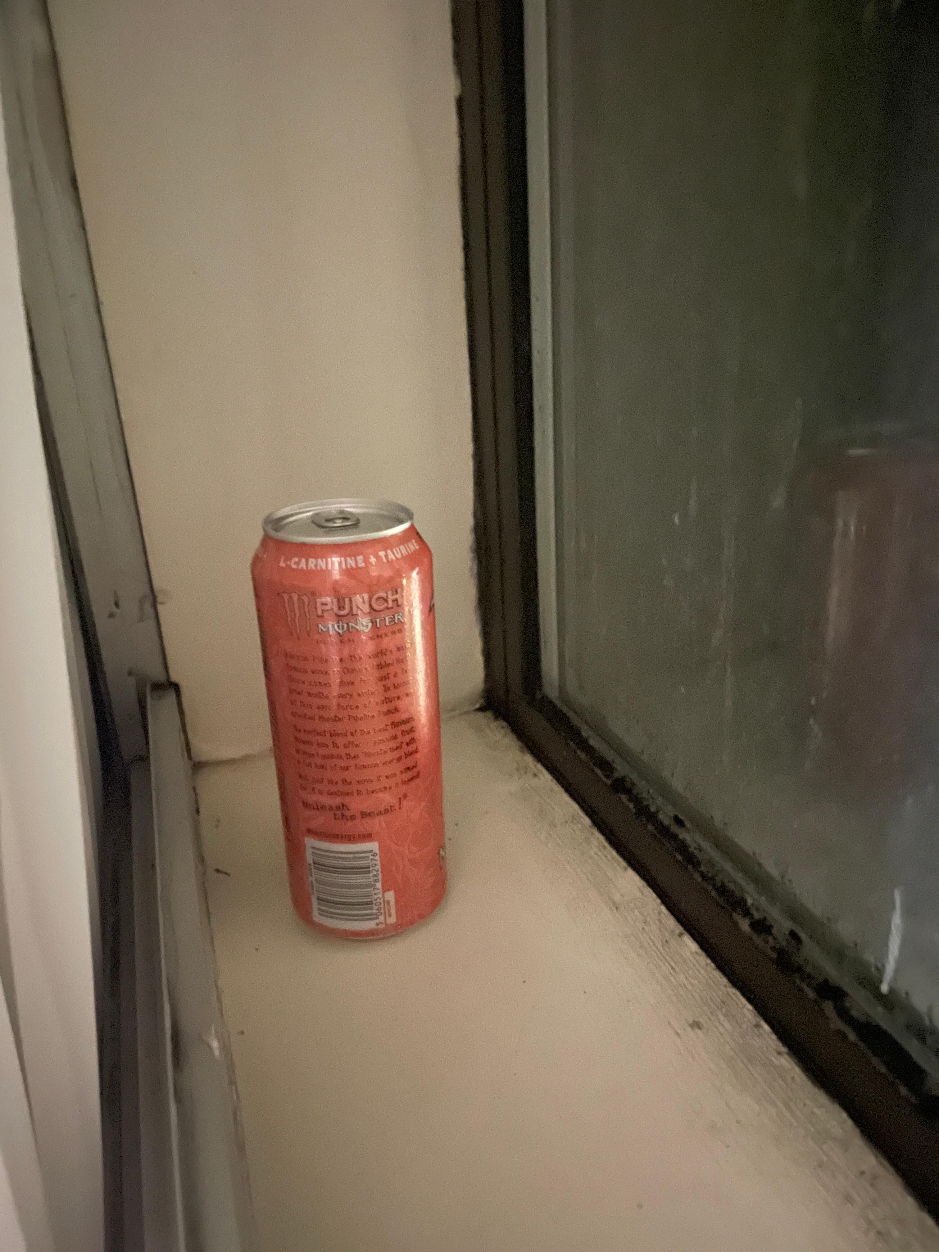 Monster energy tin by window
