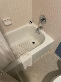 Shower tub with dirt all over the base and grime everywhere