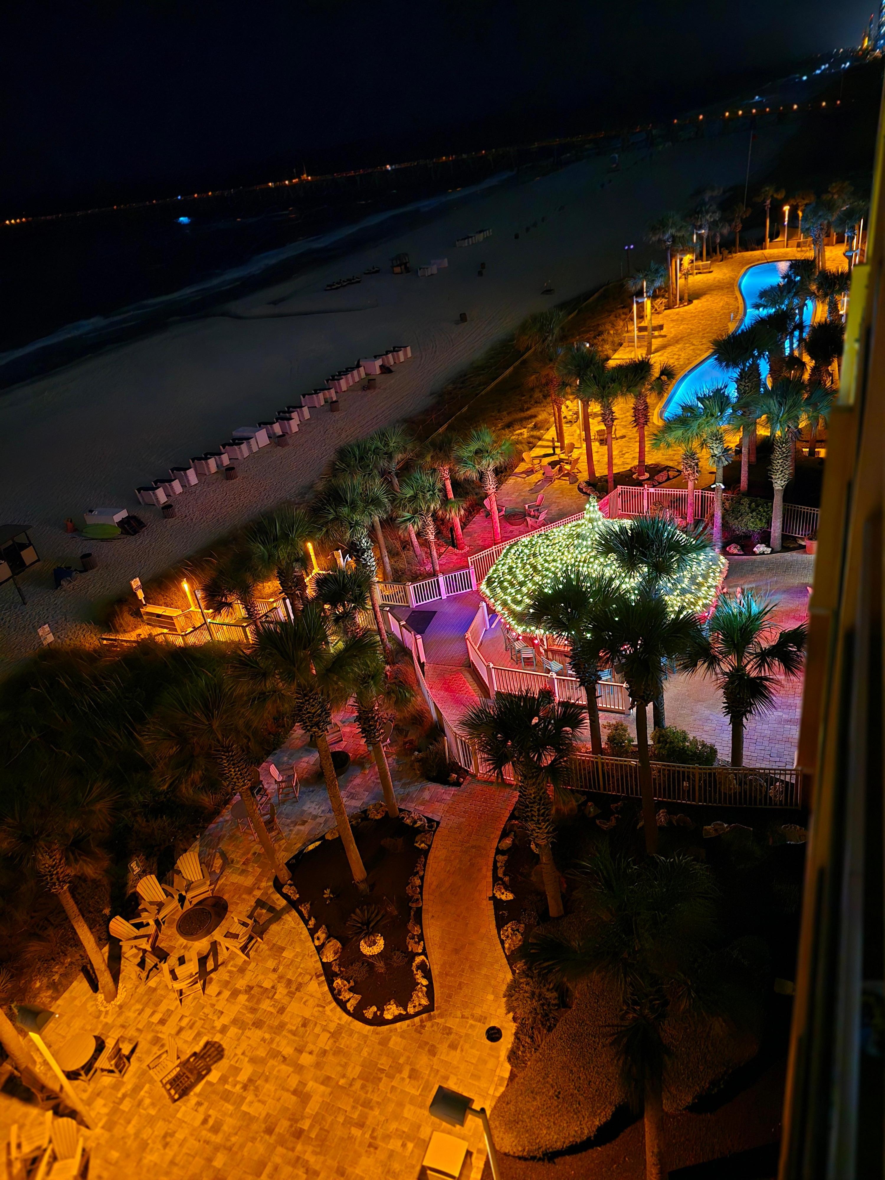 Night view of the pool, tiki and beach from balcony 