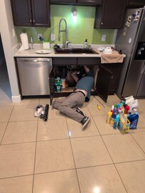 Wide Angle Shoot of Plumber Fixing Kitchen Sink