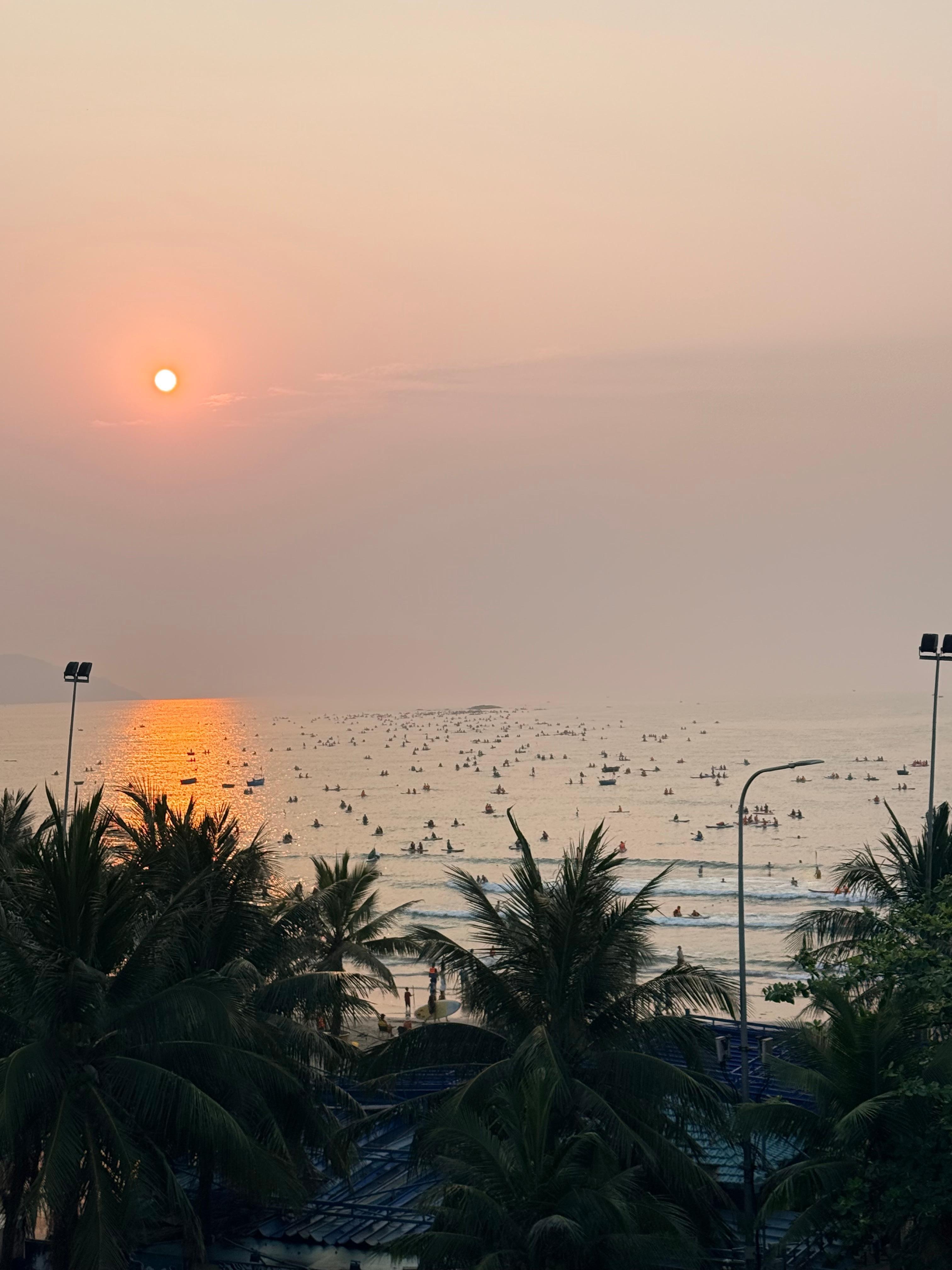 View from balcony at 5am where many people are canoeing in the sea.