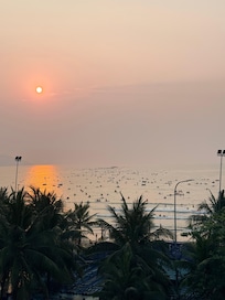 View from balcony at 5am where many people are canoeing in the sea.