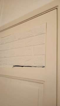 Basement windows covered with paper instead of curtains or blinds
