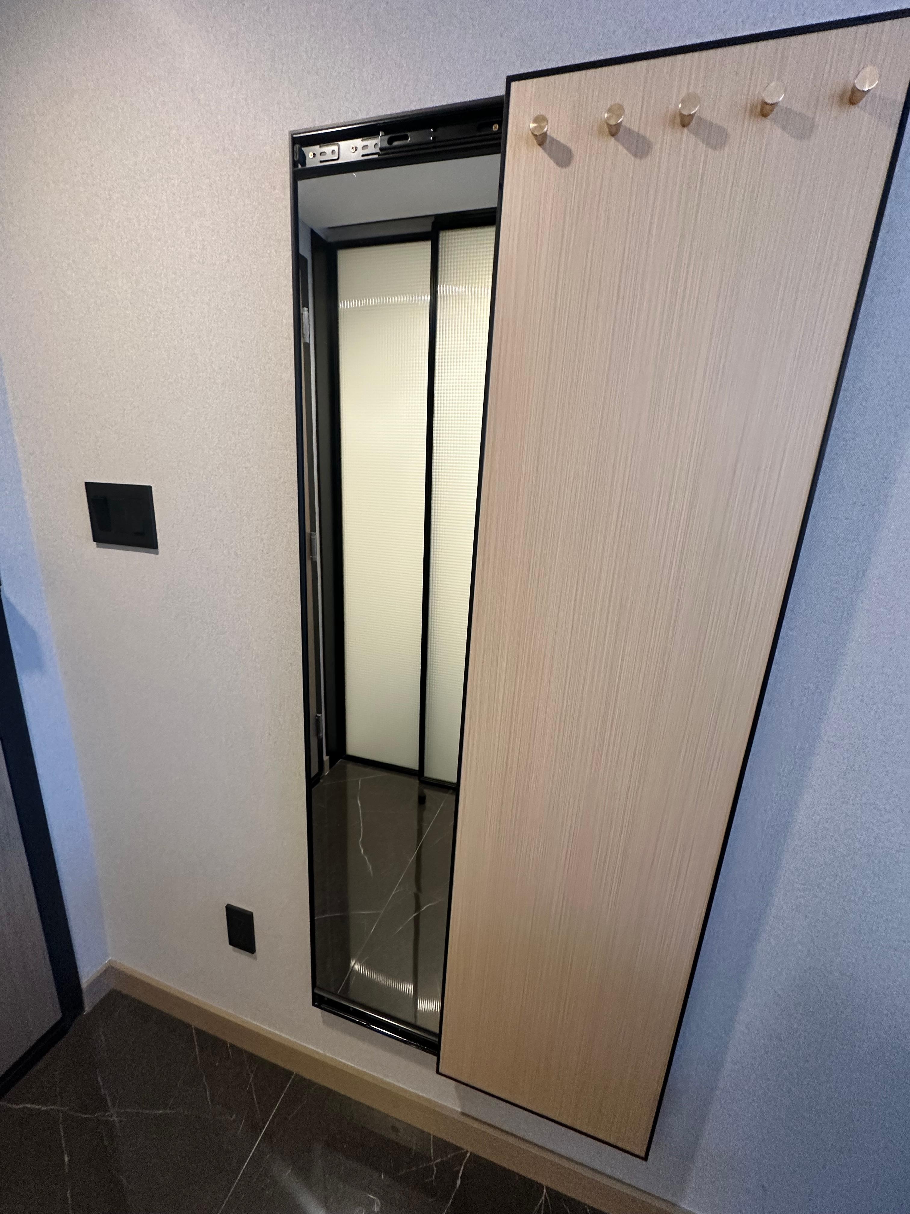 A mirror behind the only 5 tiny hooks to hang your clothes. 