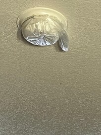 The smoke detector covered with plastic.