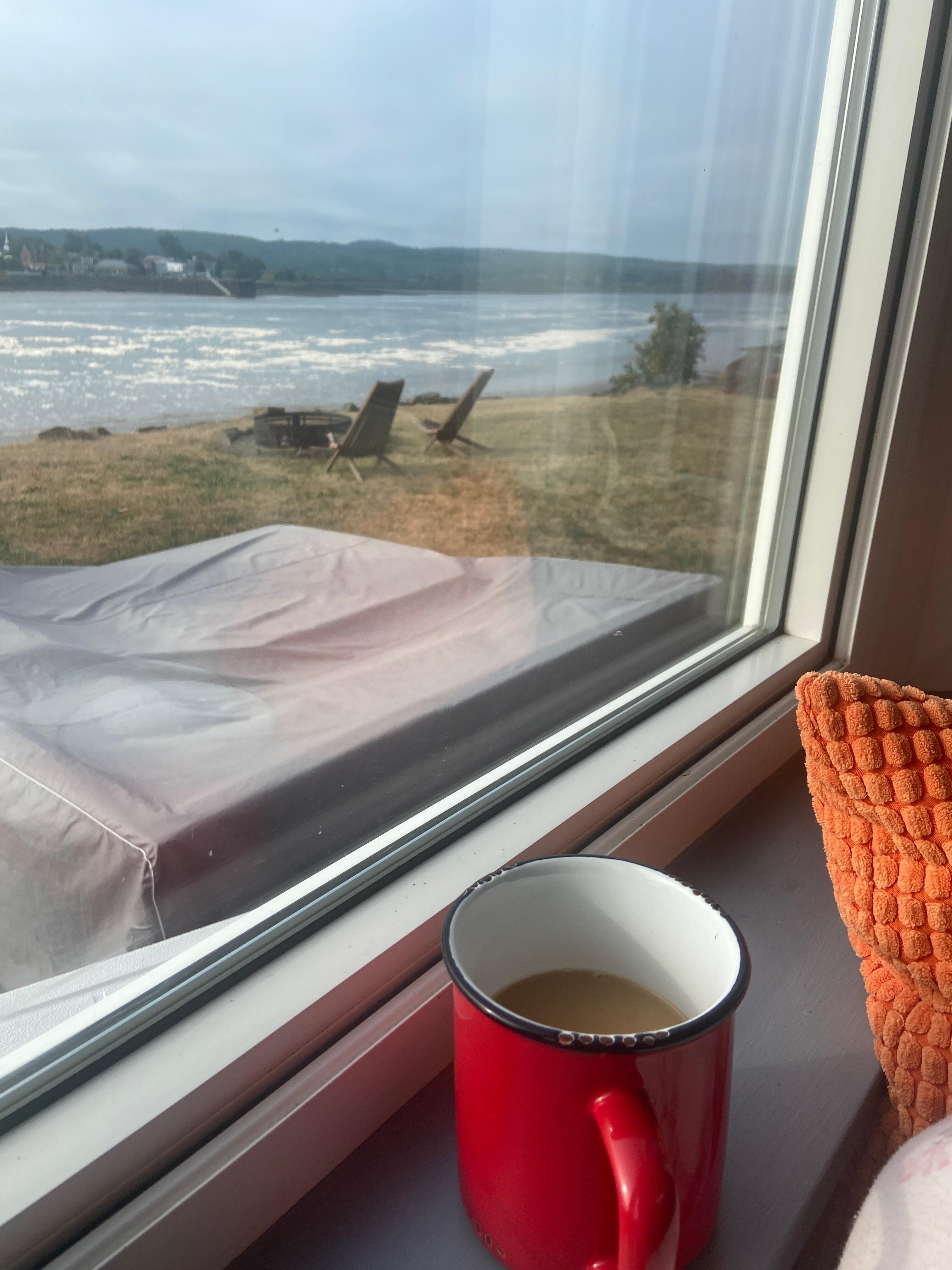 I enjoyed my coffee  while relaxing on the window seat. 