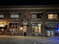 The entrance is between two businesses. Pablo’s Coffee and SubCulture.