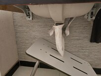 Filthy covers were over pipes under the sink.