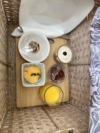 Day 2 breakfast Berry parfait, egg muffin, sliced sausage, mini muffin, fresh oj