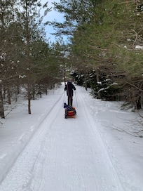 Sledding and snowshoeing on a trail near the Olympic ski jump.