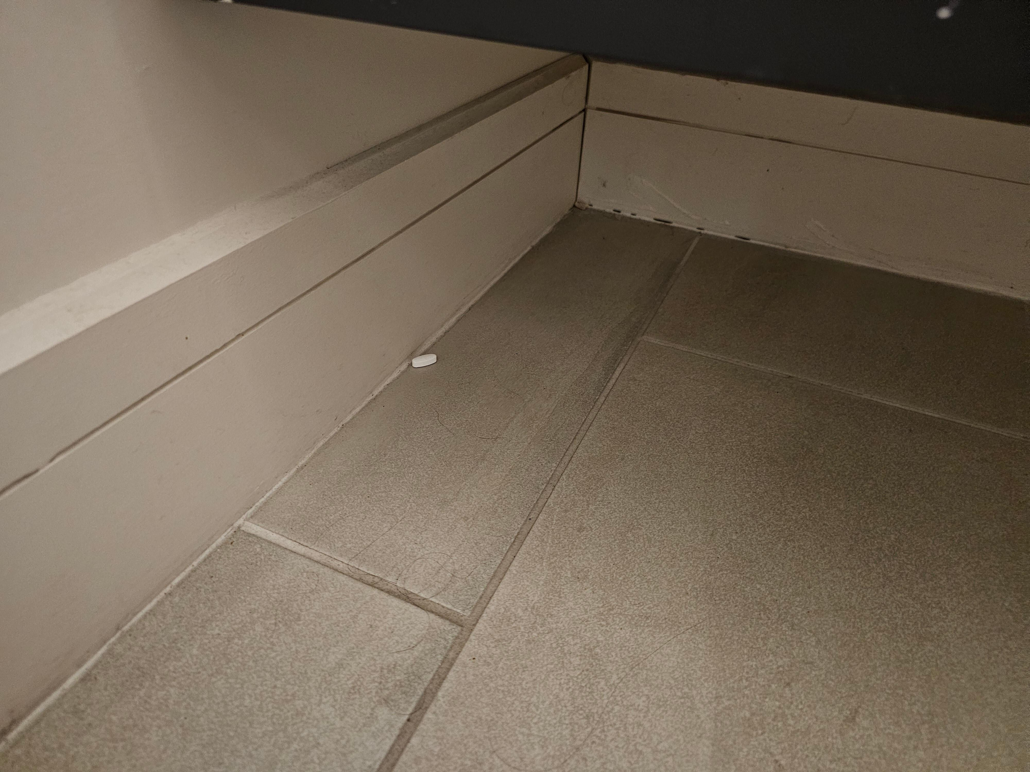 Pill on floor in bathroom