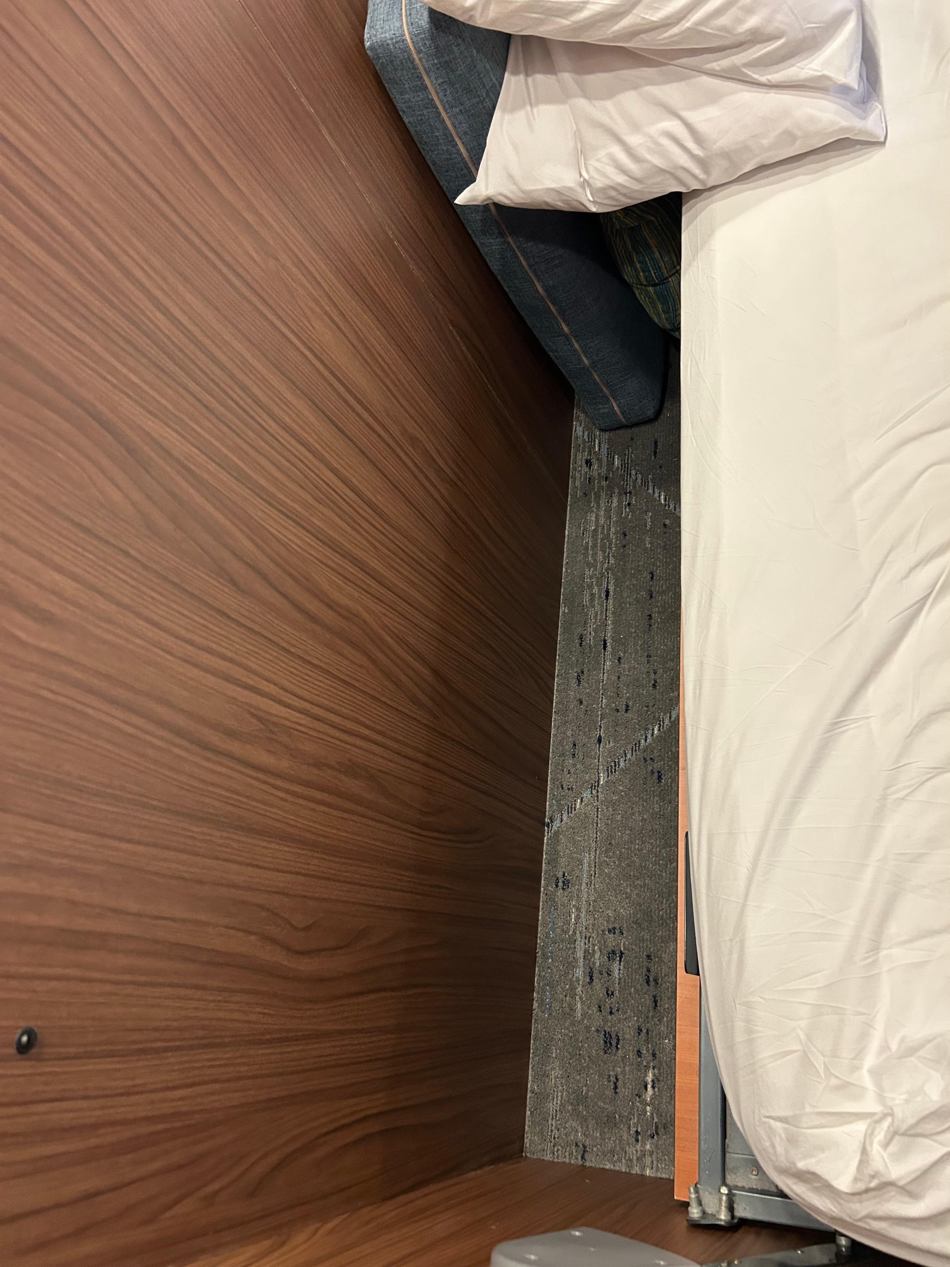 The gap between the mattress and the wall since there was no headboard. The pillows would literally keep falling into the gap all night