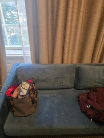 Old couch thrown in room.