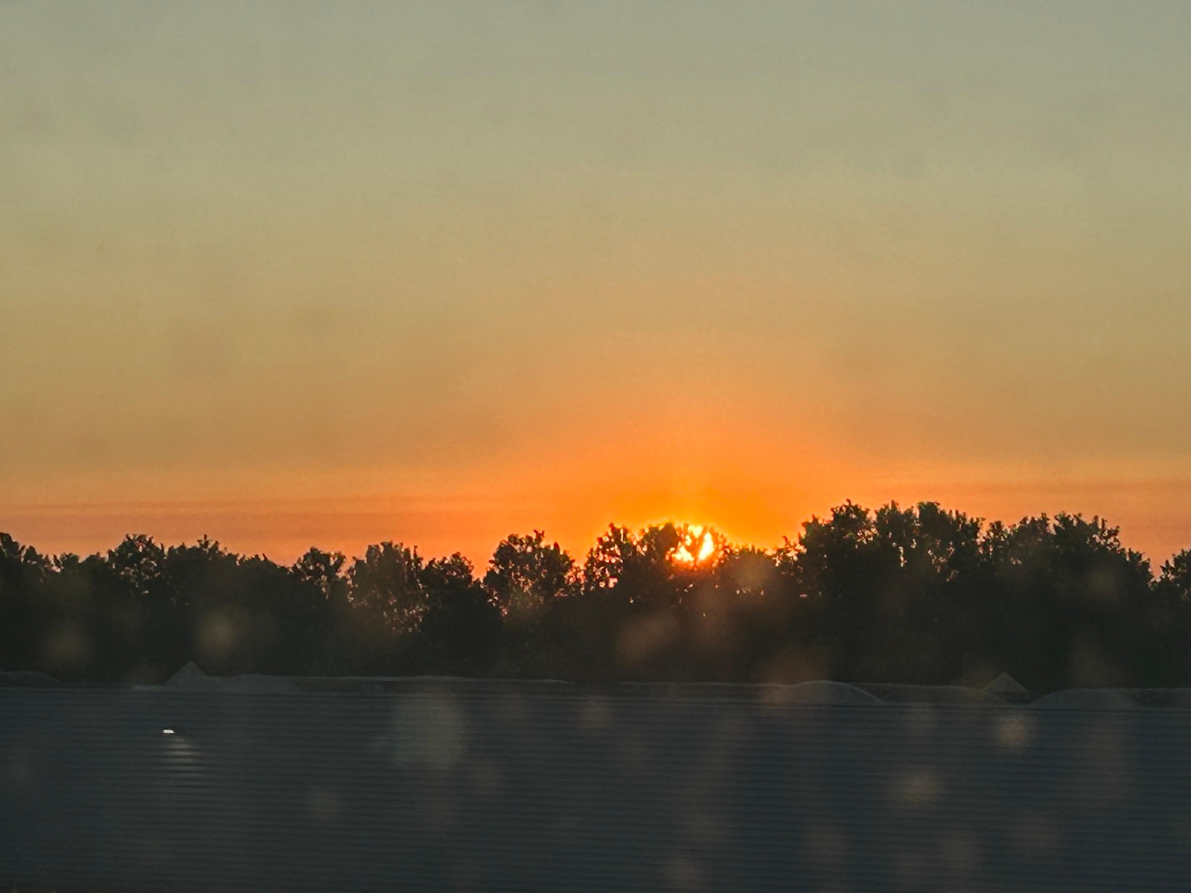View of setting sun from window